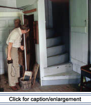 Historic architecture specialist Howard Marshall examines an interior detail of the Fred Albert house in Madawaska during fieldwork during fieldwork in 1991.
