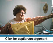 Mrs. Fabienne Landry of Edmundston, New Brunswick ripping guenilles (rag strips) for the weft of a catalogne (woven blanket with a cotton warp and salvaged cotton weft) from salvaged cotton fabric.